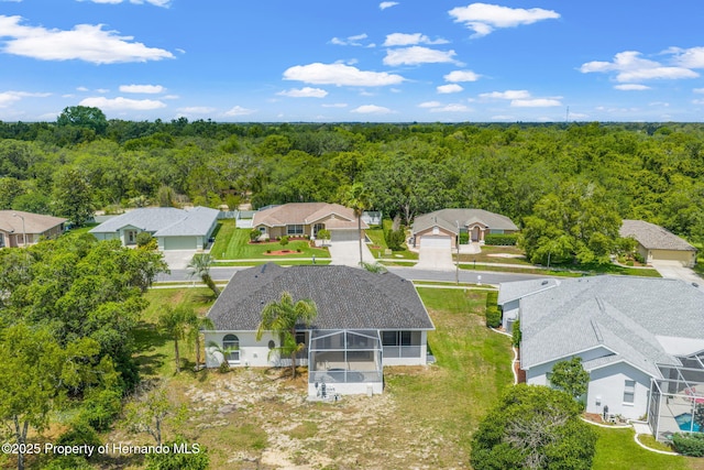 aerial view of residential area featuring a heavily wooded area
