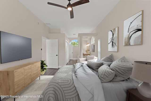 bedroom featuring wood finished floors, connected bathroom, and ceiling fan