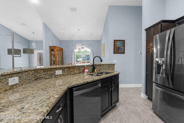 4960 Hidden Knob Trl, Spring Hill, FL 34609 - kitchen featuring black fridge, dishwasher, a sink, light stone countertops, and lofted ceiling