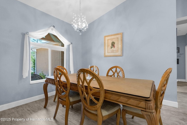 4960 Hidden Knob Trl, Spring Hill, FL 34609 - dining space featuring a chandelier, light wood-type flooring, and baseboards