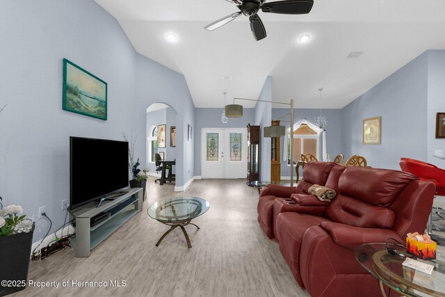 4960 Hidden Knob Trl, Spring Hill, FL 34609 - living room featuring ceiling fan, wood finished floors, arched walkways, baseboards, and high vaulted ceiling