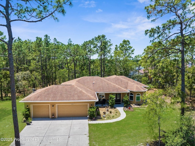 4960 Hidden Knob Trl, Spring Hill, FL 34609 - view of front of house featuring a garage, driveway, a front lawn, and stucco siding