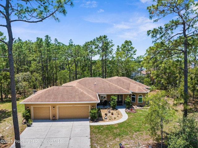 4960 Hidden Knob Trl, Spring Hill, FL 34609 - ranch-style home featuring an attached garage, driveway, a front yard, and stucco siding