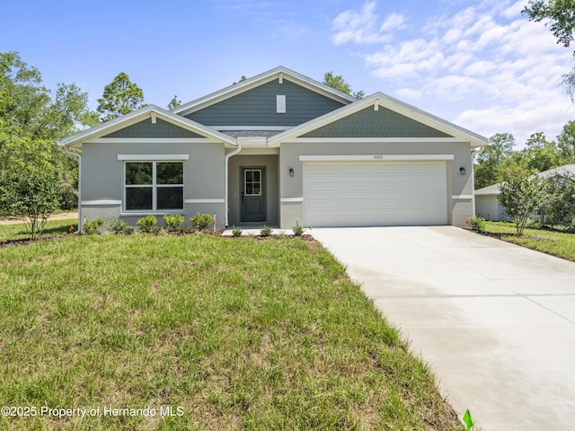 14353 Chimney Swift Rd, Weeki Wachee, FL 34614 - view of front facade with an attached garage, a front lawn, driveway, and stucco siding