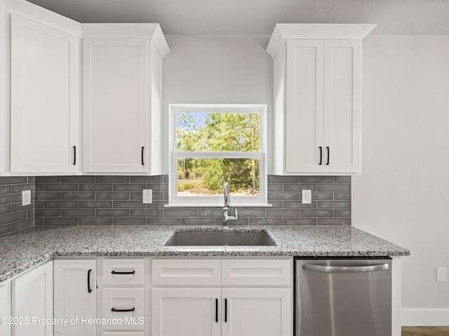 14353 Chimney Swift Rd, Weeki Wachee, FL 34614 - kitchen with dishwasher, a sink, tasteful backsplash, white cabinetry, and light stone counters
