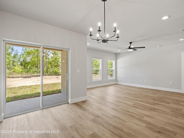 14353 Chimney Swift Rd, Weeki Wachee, FL 34614 - unfurnished room featuring a chandelier, light wood finished floors, ceiling fan, baseboards, and recessed lighting