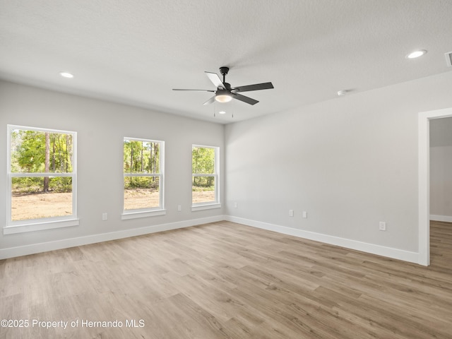 14353 Chimney Swift Rd, Weeki Wachee, FL 34614 - spare room with light wood-type flooring, ceiling fan, baseboards, and recessed lighting