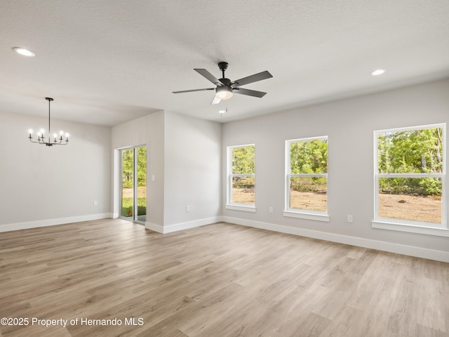 14353 Chimney Swift Rd, Weeki Wachee, FL 34614 - unfurnished room featuring light wood-style flooring, baseboards, a chandelier, a ceiling fan, and recessed lighting