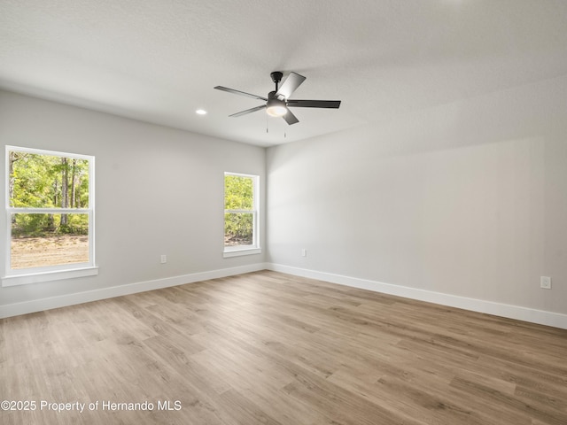 14353 Chimney Swift Rd, Weeki Wachee, FL 34614 - unfurnished room with healthy amount of natural light, light wood-type flooring, baseboards, and recessed lighting