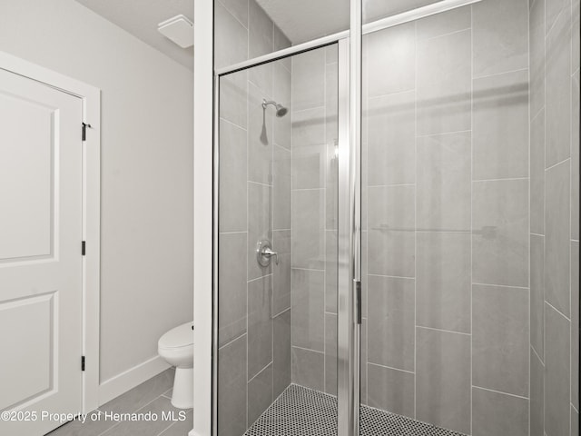 14353 Chimney Swift Rd, Weeki Wachee, FL 34614 - bathroom with a stall shower, toilet, tile patterned flooring, and baseboards