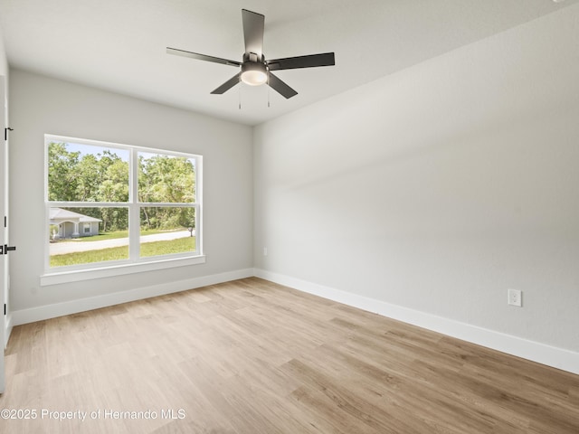 14353 Chimney Swift Rd, Weeki Wachee, FL 34614 - spare room with light wood-style floors, baseboards, and ceiling fan