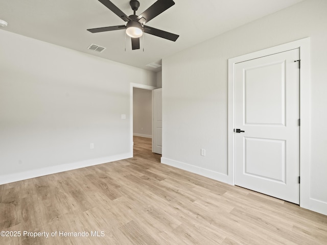 14353 Chimney Swift Rd, Weeki Wachee, FL 34614 - unfurnished bedroom featuring light wood-type flooring, baseboards, and a ceiling fan