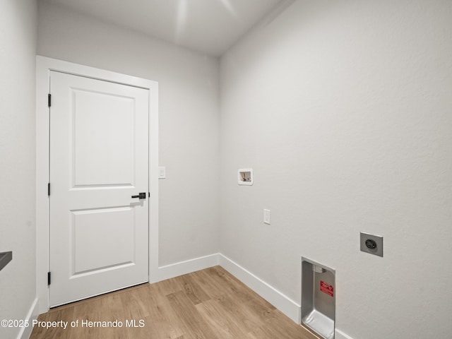 14353 Chimney Swift Rd, Weeki Wachee, FL 34614 - clothes washing area with electric dryer hookup, light wood-style flooring, baseboards, and washer hookup