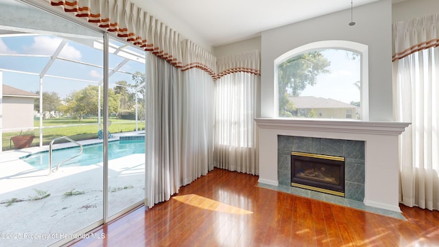4048 St Ives Blvd, Spring Hill, FL 34609 - unfurnished living room featuring wood finished floors and a tiled fireplace