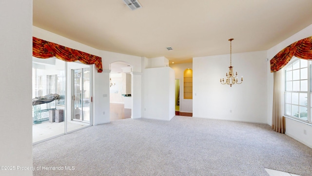 4048 St Ives Blvd, Spring Hill, FL 34609 - carpeted empty room featuring arched walkways, a chandelier, and baseboards