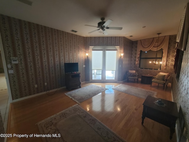 10430 Ramble Ridge Ct, Weeki Wachee, FL 34613 - living area featuring wallpapered walls, wood finished floors, and ceiling fan