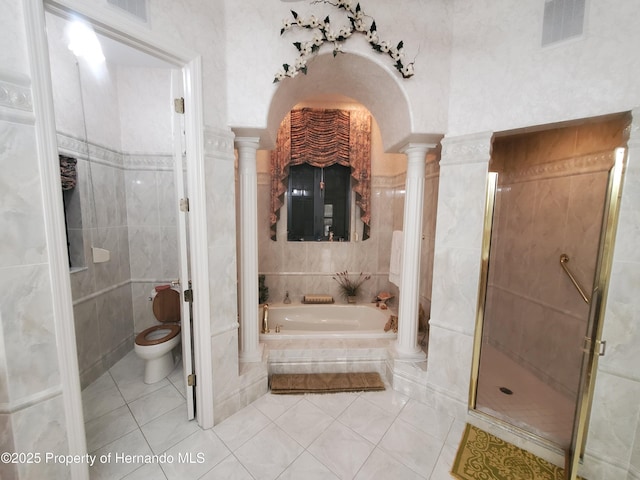 10430 Ramble Ridge Ct, Weeki Wachee, FL 34613 - full bath featuring decorative columns, tile patterned floors, a bath, toilet, and tile walls