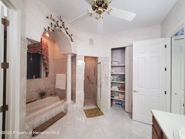 10430 Ramble Ridge Ct, Weeki Wachee, FL 34613 - bathroom with decorative columns, a garden tub, vanity, ceiling fan, and a stall shower