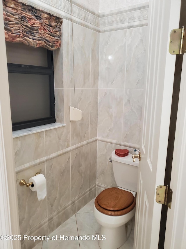 10430 Ramble Ridge Ct, Weeki Wachee, FL 34613 - bathroom with toilet, tile walls, and tile patterned flooring