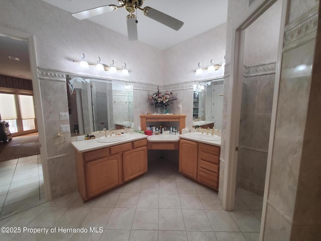 10430 Ramble Ridge Ct, Weeki Wachee, FL 34613 - bathroom with tile patterned floors, two vanities, a ceiling fan, and a shower stall