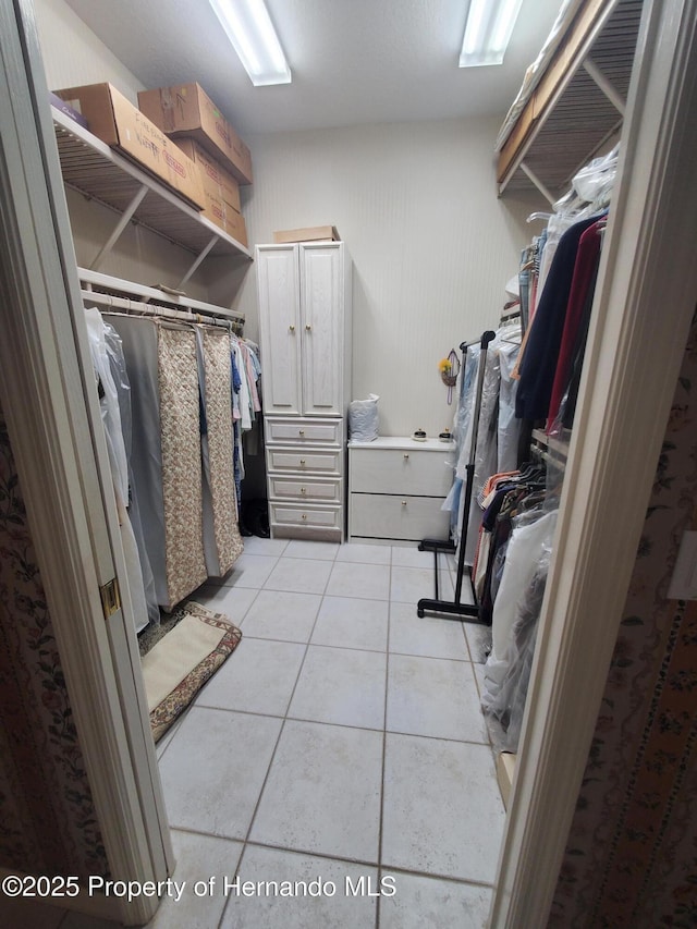 10430 Ramble Ridge Ct, Weeki Wachee, FL 34613 - walk in closet featuring light tile patterned floors