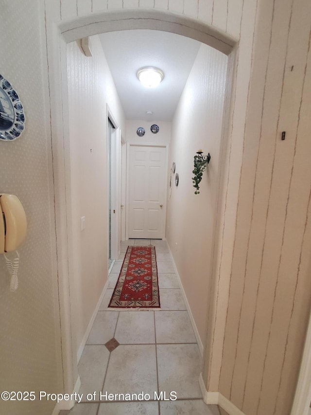 10430 Ramble Ridge Ct, Weeki Wachee, FL 34613 - corridor featuring light tile patterned floors, baseboards, and arched walkways