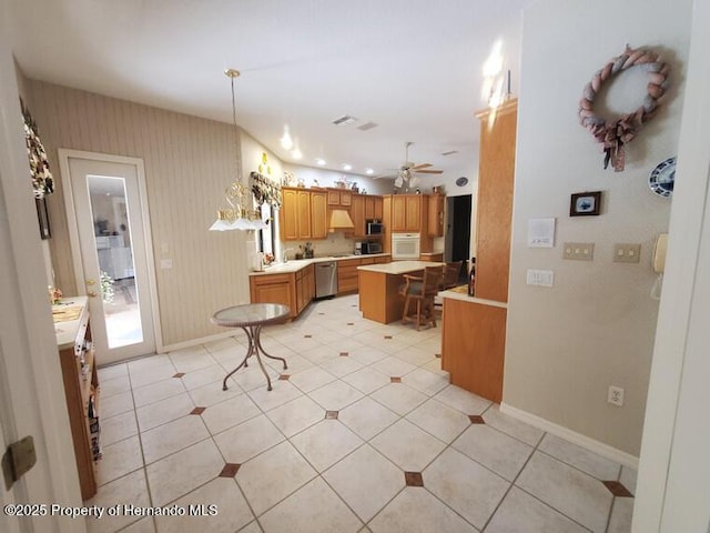 10430 Ramble Ridge Ct, Weeki Wachee, FL 34613 - kitchen featuring stainless steel appliances, light countertops, a ceiling fan, baseboards, and a center island