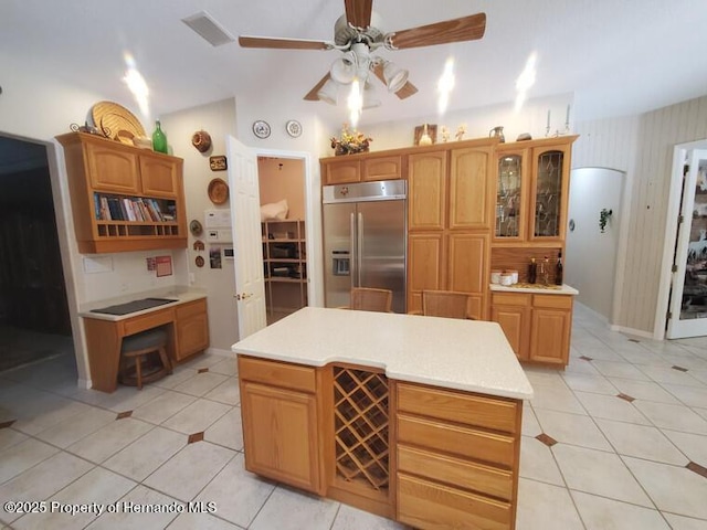 10430 Ramble Ridge Ct, Weeki Wachee, FL 34613 - kitchen featuring stainless steel built in refrigerator, a ceiling fan, light tile patterned floors, light countertops, and glass insert cabinets