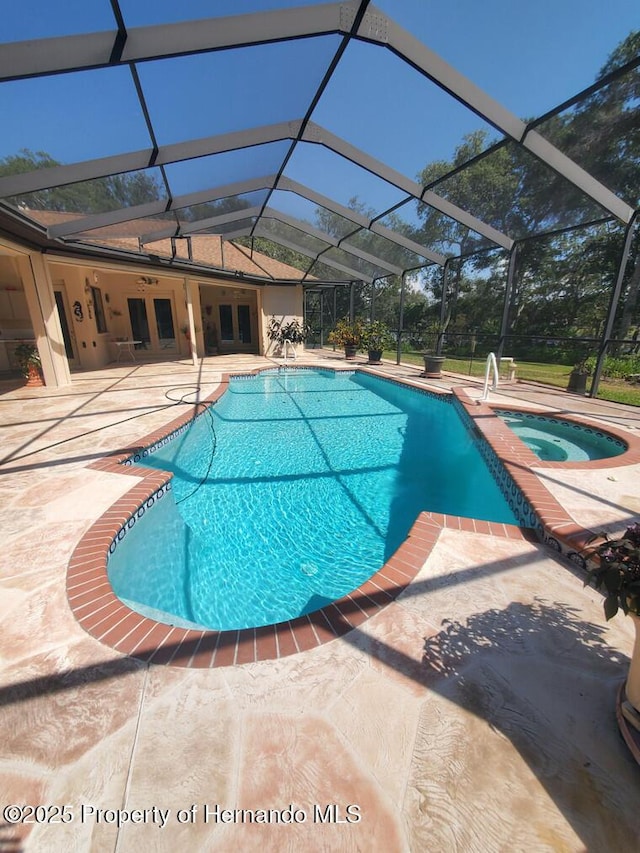 10430 Ramble Ridge Ct, Weeki Wachee, FL 34613 - outdoor pool with an in-ground hot tub, a patio, glass enclosure, and french doors