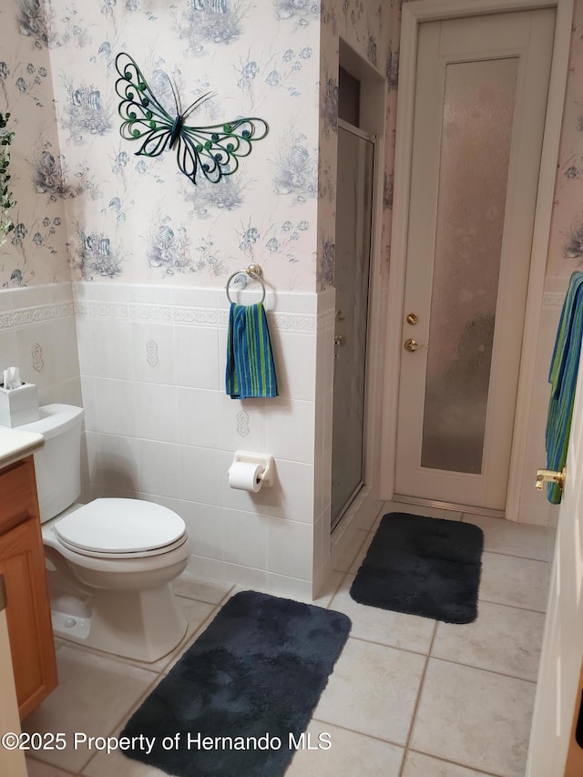 10430 Ramble Ridge Ct, Weeki Wachee, FL 34613 - bathroom with wallpapered walls, a wainscoted wall, tile patterned floors, vanity, and a shower stall