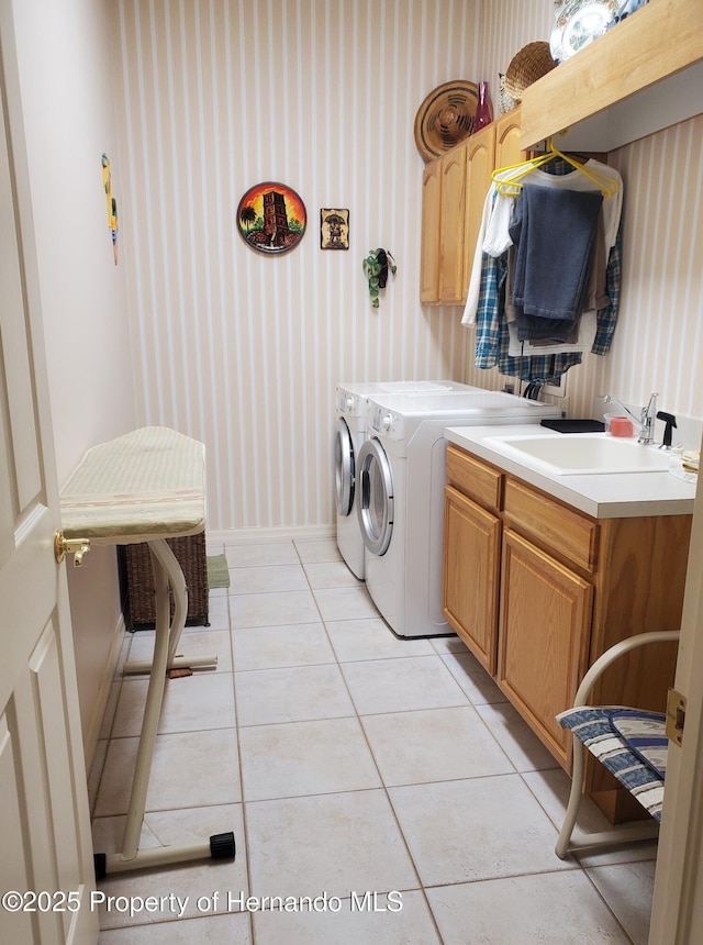 10430 Ramble Ridge Ct, Weeki Wachee, FL 34613 - laundry area featuring wallpapered walls, cabinet space, independent washer and dryer, baseboards, and light tile patterned floors
