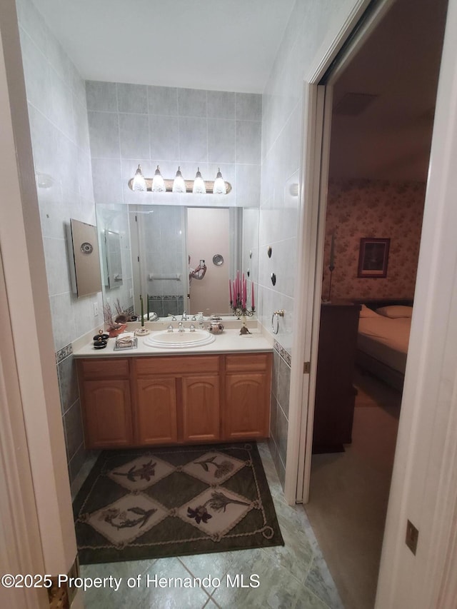 10430 Ramble Ridge Ct, Weeki Wachee, FL 34613 - bathroom featuring tile walls and vanity