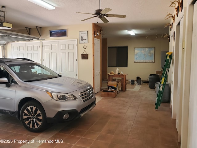 10430 Ramble Ridge Ct, Weeki Wachee, FL 34613 - garage featuring a garage door opener and a ceiling fan
