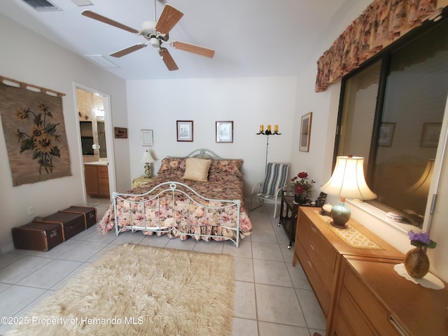 10430 Ramble Ridge Ct, Weeki Wachee, FL 34613 - bedroom with light tile patterned floors, connected bathroom, and ceiling fan