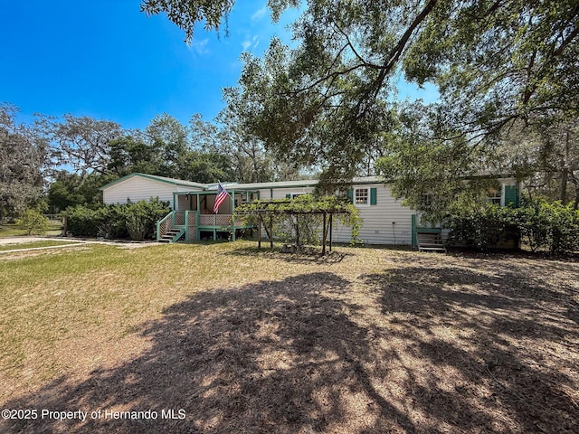 16173 Wiscon Rd, Brooksville, FL 34601 - back of house with a wooden deck and a yard