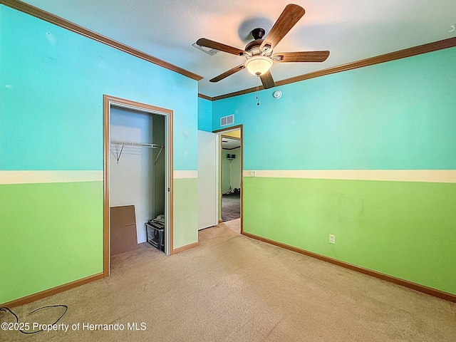 16173 Wiscon Rd, Brooksville, FL 34601 - unfurnished bedroom featuring a closet, ornamental molding, carpet flooring, baseboards, and a ceiling fan