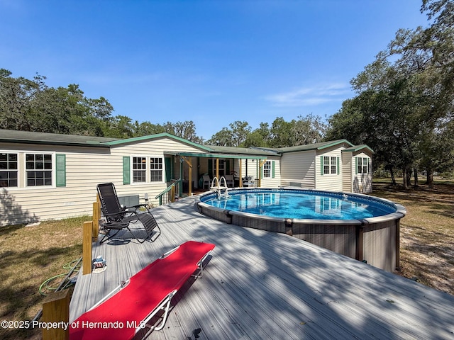 16173 Wiscon Rd, Brooksville, FL 34601 - outdoor pool with a wooden deck and an outbuilding