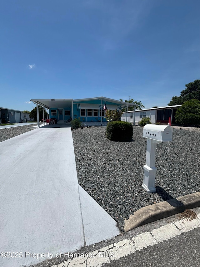 15693 Brookridge Blvd, Brooksville, FL 34613 - manufactured / mobile home with driveway and an attached carport