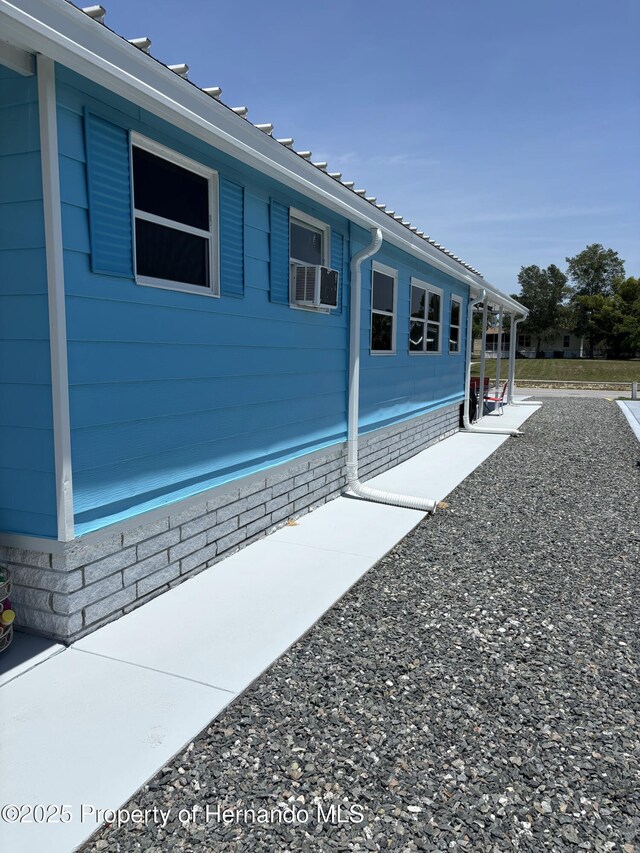 15693 Brookridge Blvd, Brooksville, FL 34613 - view of side of property featuring cooling unit
