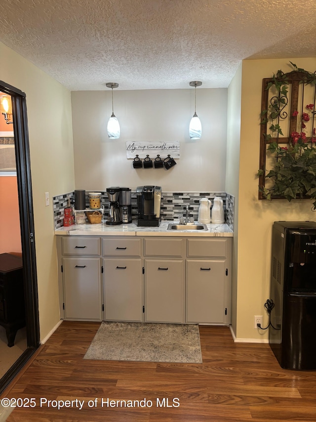 15693 Brookridge Blvd, Brooksville, FL 34613 - kitchen with a sink, dark wood-type flooring, tasteful backsplash, a textured ceiling, and light countertops