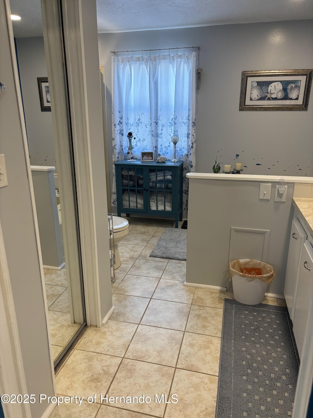 15693 Brookridge Blvd, Brooksville, FL 34613 - bathroom featuring toilet, tile patterned flooring, and vanity