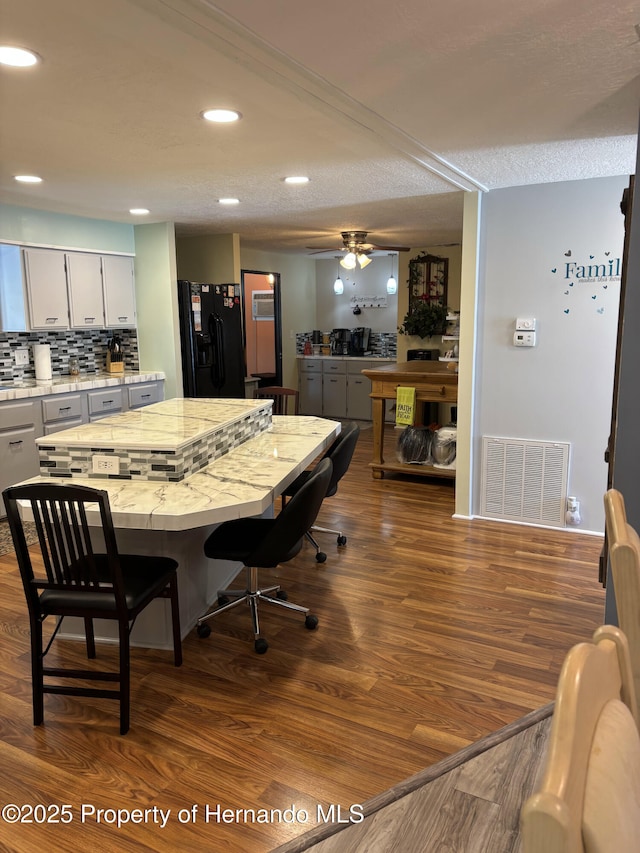 15693 Brookridge Blvd, Brooksville, FL 34613 - dining space with dark wood finished floors, recessed lighting, a ceiling fan, and a textured ceiling