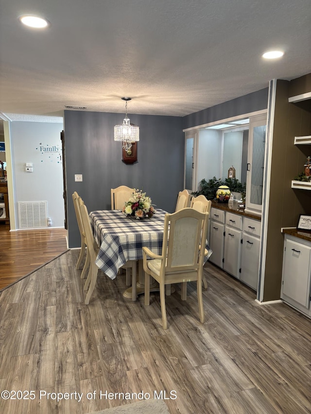 15693 Brookridge Blvd, Brooksville, FL 34613 - dining room featuring wood finished floors, a chandelier, and recessed lighting