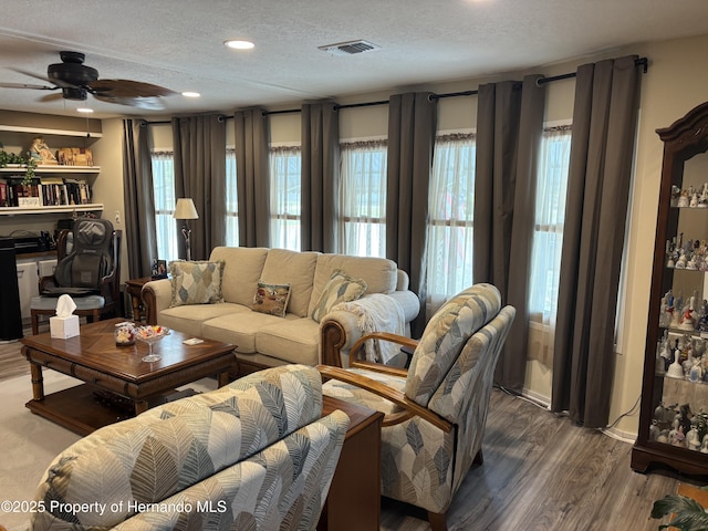 15693 Brookridge Blvd, Brooksville, FL 34613 - living area with a textured ceiling, plenty of natural light, a ceiling fan, wood finished floors, and recessed lighting