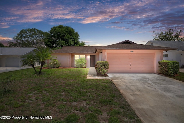 10820 Hachita Dr, Port Richey, FL 34668 - single story home with concrete driveway, a garage, stucco siding, and a front lawn