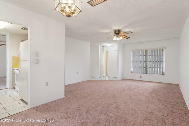10820 Hachita Dr, Port Richey, FL 34668 - empty room with light carpet, a ceiling fan, and a chandelier