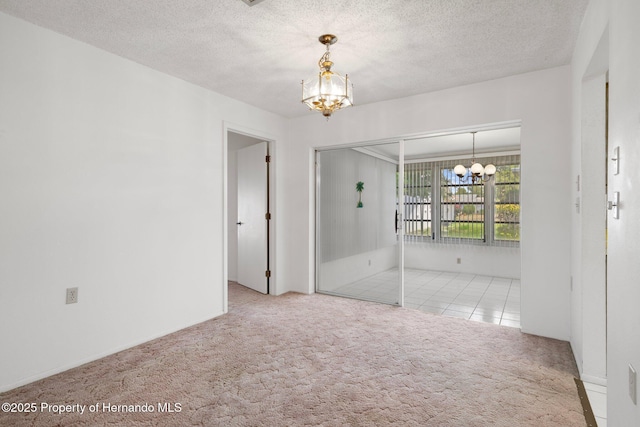 10820 Hachita Dr, Port Richey, FL 34668 - empty room with a chandelier, carpet floors, and a textured ceiling