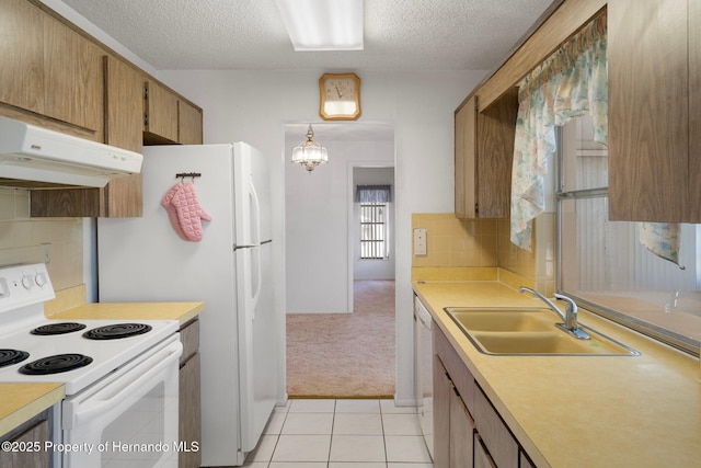 10820 Hachita Dr, Port Richey, FL 34668 - kitchen featuring white electric stove, a sink, under cabinet range hood, a textured ceiling, and light countertops