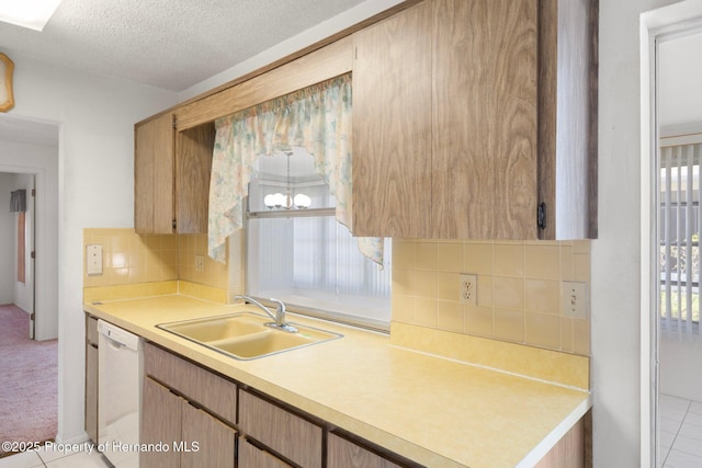 10820 Hachita Dr, Port Richey, FL 34668 - kitchen with a sink, dishwasher, light countertops, backsplash, and a textured ceiling