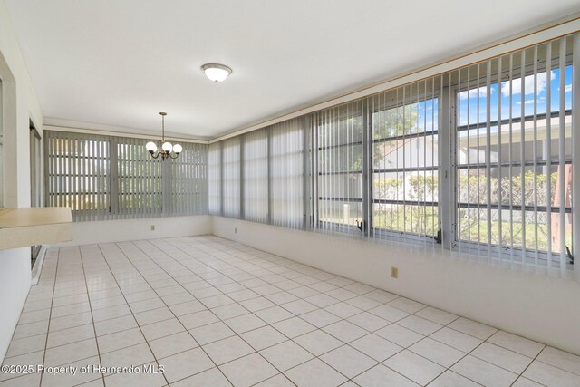 10820 Hachita Dr, Port Richey, FL 34668 - unfurnished sunroom featuring a chandelier
